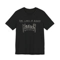 She Likes It Rough — Black tee, front
